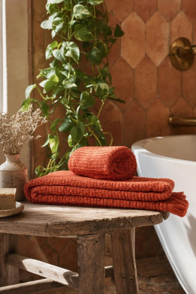 Cinnamon handwoven Turkish cotton loop towels in a terracotta bathroom