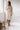 Oatmeal muslin cotton robe in a bright bathroom, morning coffee