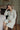 Pastel matcha muslin cotton robe worn as a maternity robe in a sage green room