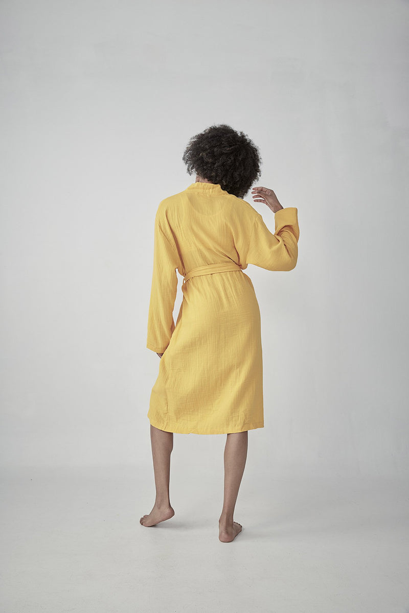 Comfortable bright yellow Turkish cotton bathrobe with a waffle texture, ideal for lounging, featured on ReplenishGoods.com.